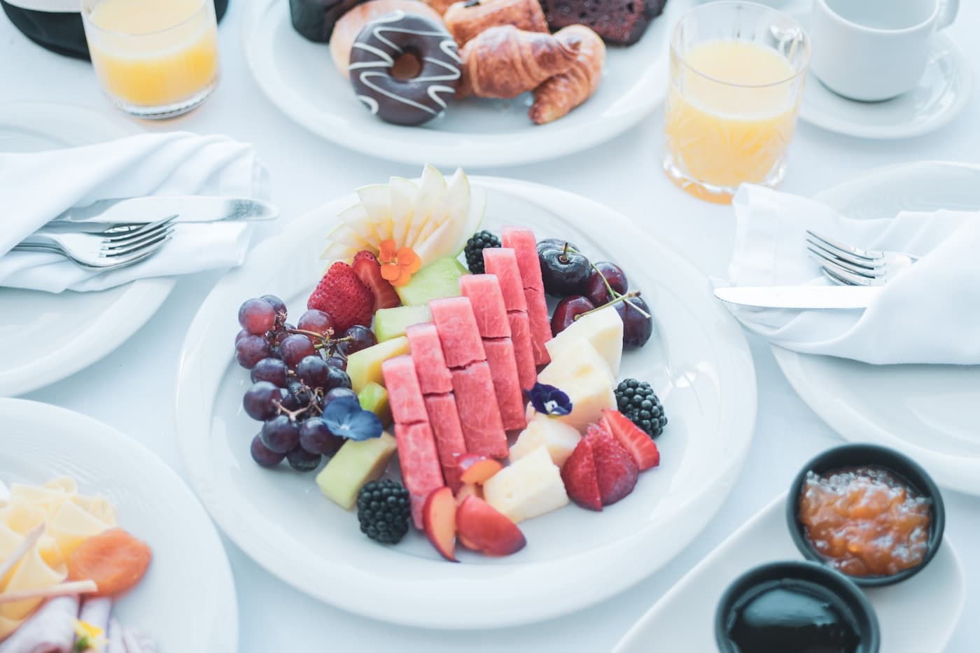 Lunch laid out on a boat table — fresh fruit, mezze and juices