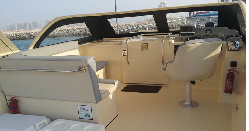 Speed boat crossing in front of the West Bay skyline in Doha