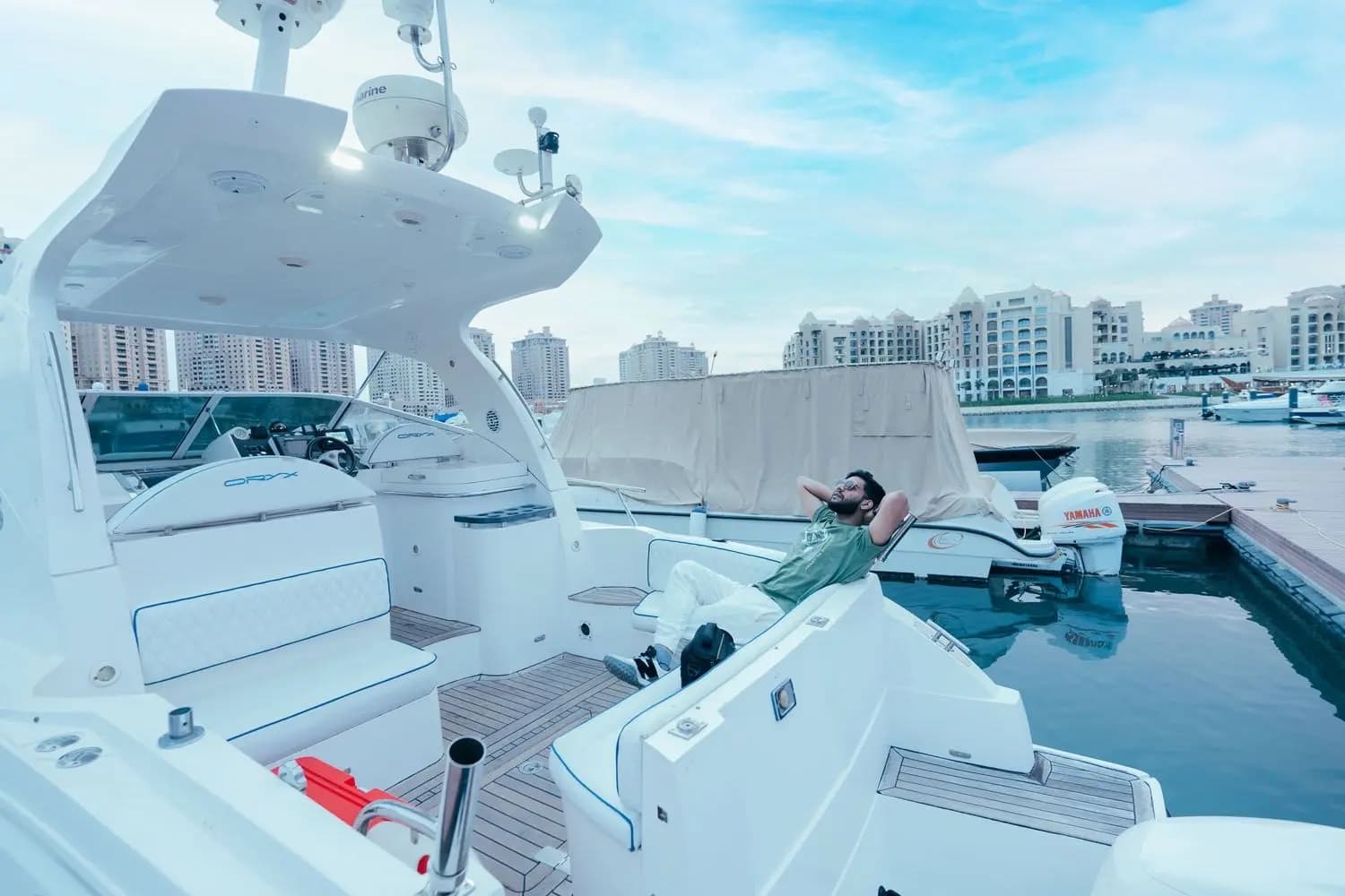 Boat moored at Porto Arabia with the towers of The Pearl-Qatar behind